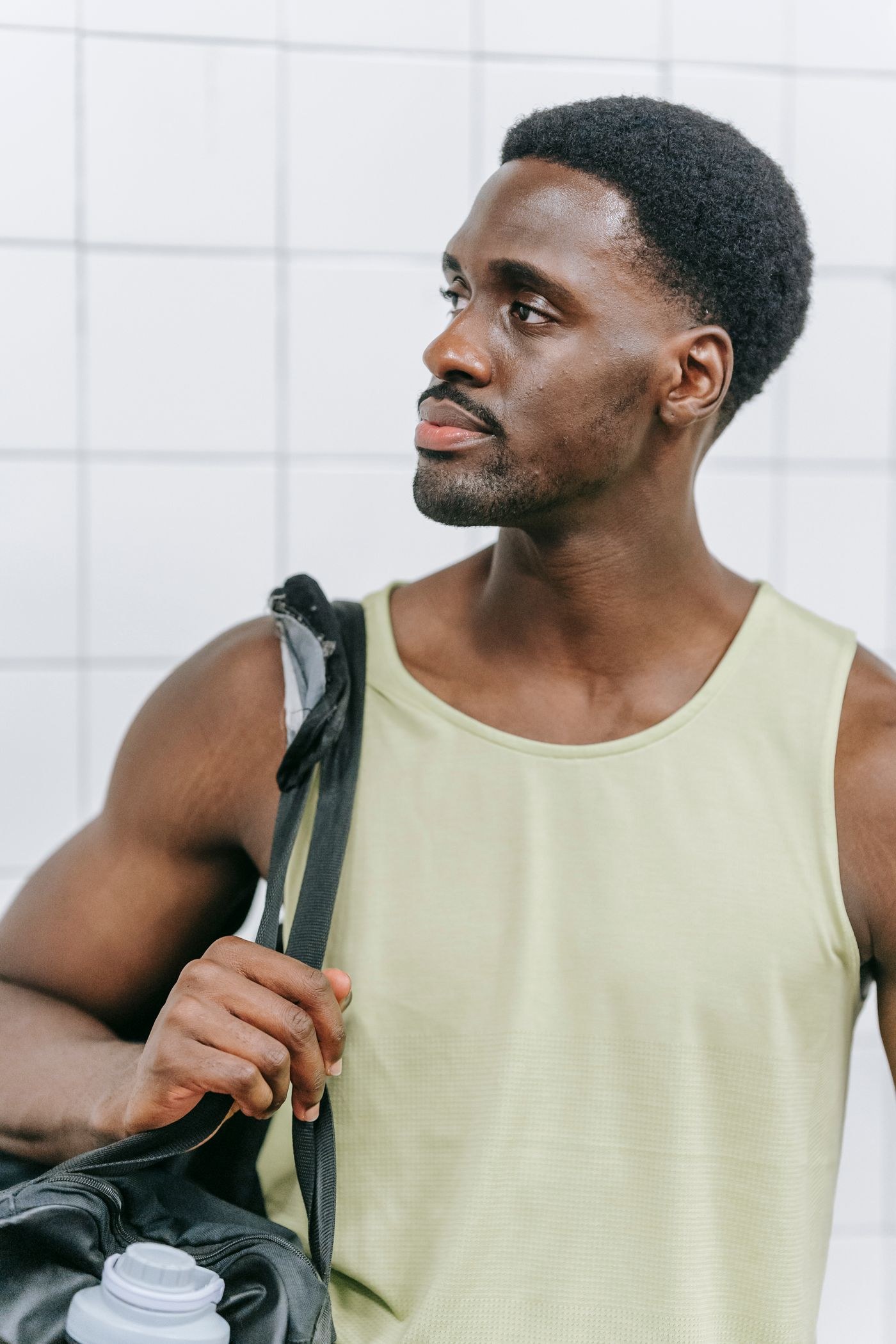 A man carrying a gym bag over his shoulder.